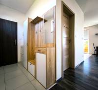 Hallway in a 2-room apartment with furniture and a view into the dining room.