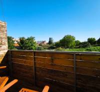 Wooden balcony with a view of greenery in a 2-room apartment on Pri Maline Street, Malacky.