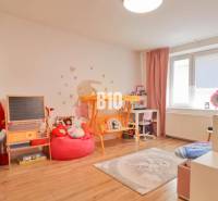 Children's room in a family house with toys, books, a blackboard, and an aquarium.