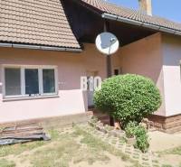A family house in Podhradie with a satellite dish and landscaped outdoor area.