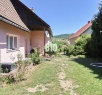 A garden at a family house in the town of Podhradie with a lawn and surrounding nature.