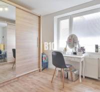 Wardrobe and dressing table in the interior of a family house with a large mirror and spacious closet.