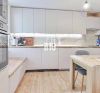 Kitchen in a family house with a countertop, oven, and dining table.
