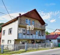 A family house in Turzovka with flowers on the balcony and a satellite dish.