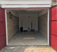 Open garage with brick walls on Michalovská Street, Košice - Západ district.