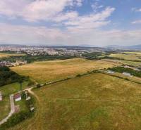 Aerial view of agricultural and forest lands with the city of Košice, district Luník IX.