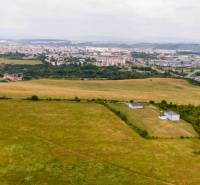 Agricultural and forest lands in Košice, Luník IX district, with the city in the background.