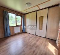 Chat room with light wooden walls, floor, and a large window.
