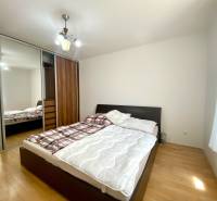Bedroom with a bed and built-in wardrobe in a 2-room apartment.