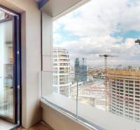 A balcony of a 2-room apartment with a view of towers and cranes in Bratislava - Old Town.