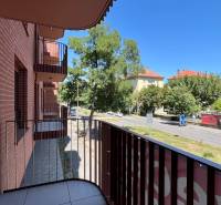 The balcony of an apartment on Cvernovka Street in Bratislava - Ružinov with greenery and a road.