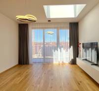 Living room in a two-room apartment with a TV and decorations on the floor.