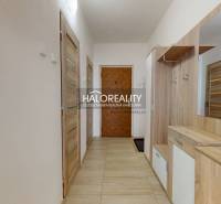 Hallway in a 3-room apartment with wooden furniture and tiled floor.