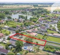 Aerial view of a plot in Čiližská Radvaň, suitable for living, with surrounding houses.