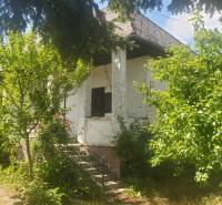 A family house on Mostová Street in Sečovce surrounded by greenery and trees.