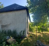 A family house on Mostová Street in Sečovce with a large garden and trees.