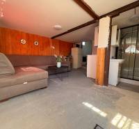 Interior with seating, shower corner, and kitchenette in the Gardens.