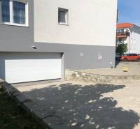 In Slovenský Grob on Rastislavova Street, there are garages near residential buildings.
