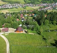 Aerial view of recreational plots in Vyšné Ružbachy surrounded by greenery and village houses.