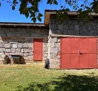 Stone shelter with red doors in the garden of a family house in Slovenská Kajňa.