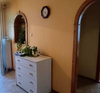 Dining room with chairs, arched doors leading to bedrooms, interior of a 3-room apartment.