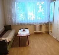 A room in a 3-room apartment with a sofa, a table, and a large wardrobe.