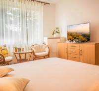 A bright interior in a studio apartment with comfortable armchairs and a television.