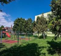 A children's playground with climbing frames and a slide in the town of Číčov near a one-bedroom apartment.
