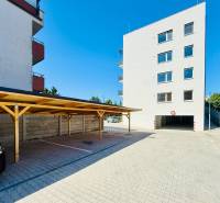 Parking lot and apartment building on Geologická Street in Bratislava - Podunajské Biskupice.