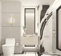 A bathroom in a 3-room apartment with marble tiles and a large mirror.