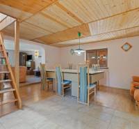 Wooden interior of the cabin with a dining table and comfortable seating.