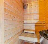 A wooden sauna in the cottage provides a place for relaxation and rest with a stone stove.