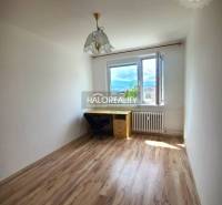 Bright room in a 3-room apartment with wooden flooring, a desk, and a chair.