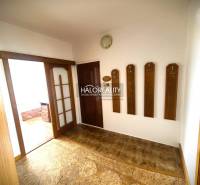 Entrance hallway in a 3-room apartment with a coat rack and sliding doors.