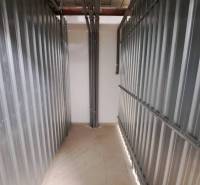 Storage space in a 2-room apartment with metal walls and pipes.