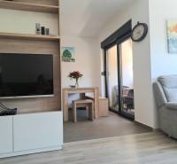 Living room in a 3-room apartment with a television and a comfortable armchair.