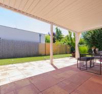Terrace of a family house in Senec with seating and a pergola, view of the garden.