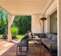 Terrace with seating in a family house in Senec, with a garden and greenery.