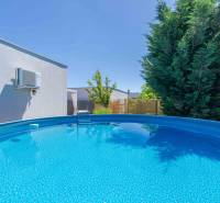 In the garden of a family house in Senec, there is a circular pool.