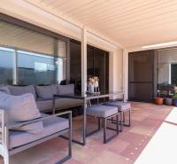 The terrace of a family house in Senec with outdoor seating and flower pots.