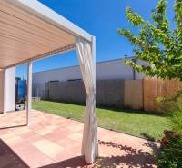 A terrace of a family house in Senec with a garden and a modern pergola.