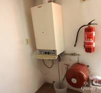 Heating in the building with a boiler and a fire extinguisher on the wall.