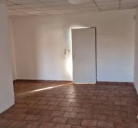 The interior of the building with white walls and tiled flooring.