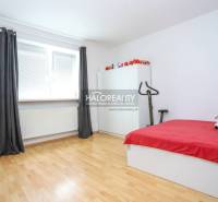 A room in a family house with a bed, a wardrobe, and exercise equipment.