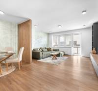Living room in a 3-room apartment with a sofa, dining table, and modern furniture.