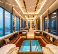 Luxurious interior with panoramic views, sofas, and marble tables within the apartment construction.