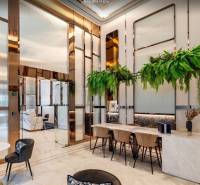 Luxurious interior with white marble furniture and green plants in apartment construction.
