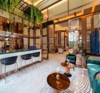 Interior of a luxurious living room with a bar counter and designer furniture. Apartment construction.