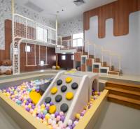 A play corner with balls and a slide in the premises of apartment construction.