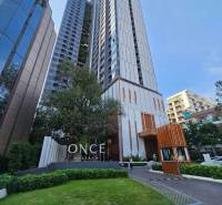 Apartment construction in Pattaya with high-rise buildings and landscaped green surroundings.